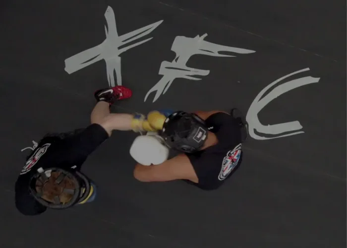 Supervised sparring in headgear, seen from above