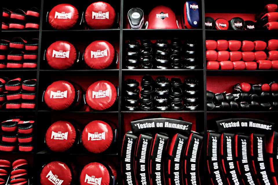 Medicine balls, pads and striking equipment on storage racks